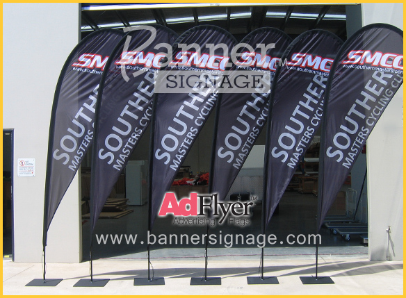 Black teardrop advertising flags outside the flag factory shows the height and color depth. The AdFlyer range of teardrop flags is the best.